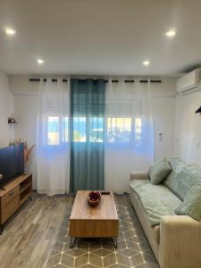 a living room with a couch and a coffee table at Charmant studio île & cap in Bastia