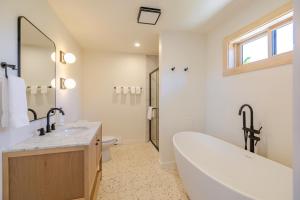 a bathroom with a tub and a toilet and a sink at Adirondack Spruce Lodge in Wilmington +55 photos