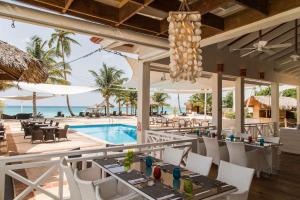 a restaurant with a view of the ocean and a pool at Cadaques Caribe Bayahibe Palmera in Bayahibe