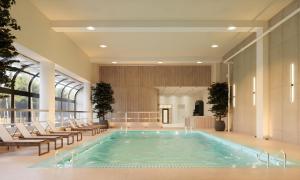 a pool in the lobby of a building with chairs at Chelsea Hotel Toronto in Toronto