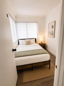 a bedroom with a bed and a window at Santorini Shores in Biscayne Park