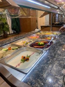 a buffet line with many different types of food at فندق قصر السدير in Baghdād +13 photos