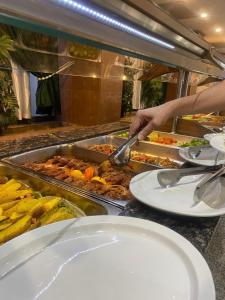 a person is preparing food in a buffet at فندق قصر السدير in Baghdād