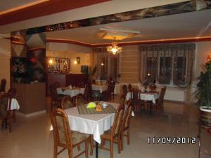a dining room with tables and chairs in a restaurant at Zajazd-Restauracja ELZA in Kutno
