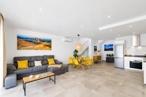 a living room with a couch and a table at Villa Maria 7 in Puerto Calero