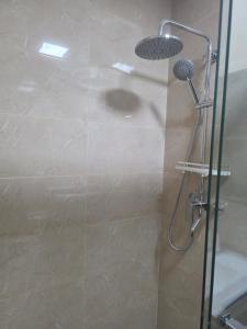 a shower with a glass door in a bathroom at Megarich Studio in Megatower VII in Baguio