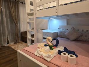 a room with two bunk beds with towels on a table at Megarich Studio in Megatower VII in Baguio