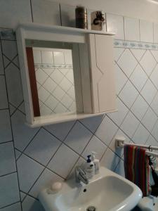 a bathroom with a sink and a medicine cabinet at Appartamento in VILLA spazio esterno e posto auto in Rio nellʼElba