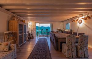 a dining room with a wooden table and chairs at Zuani Casa in San Floriano del Cóllio