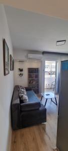 a bedroom with a bed and a table in a room at Tri Kule Apartman in Bar