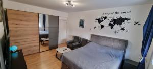a bedroom with a map of the world on the wall at Tri Kule Apartman in Bar +8 photos