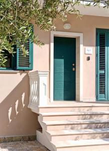 a house with a green door and stairs at B&B Clav's Home - bebclavshome in Pozzilli