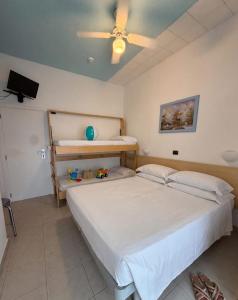 a bedroom with a bed and a ceiling fan at Nautilus Hotel in Bellaria-Igea Marina