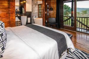 a bedroom with a large bed and a balcony at 56 Crocodile in Komatipoort +50 photos