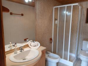 a bathroom with a sink and a toilet and a shower at Gerês by Papitravel in Vieira do Minho +14 photos