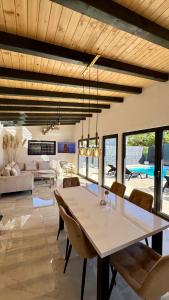 a dining room and living room with a table and chairs at Villa SARA Bugojno in Bugojno