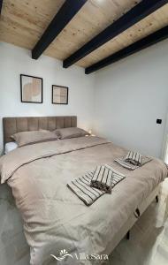 a large bed in a white bedroom with wooden ceilings at Villa SARA Bugojno in Bugojno +22 photos