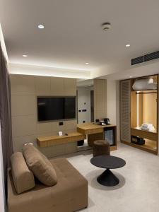 a living room with a couch and a flat screen tv at DriArt Center in Tirana