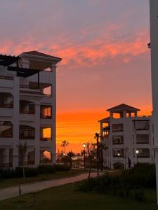 a building with the sunset in the background at Asilah in Asilah