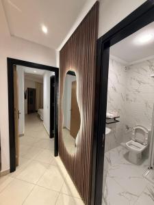 a bathroom with a toilet and a mirror at Asilah in Asilah +11 photos