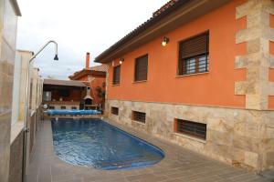 a swimming pool in front of a house at Villa de Lujo con Piscina A 5 min de San Juan de los Terreros in Pulpí