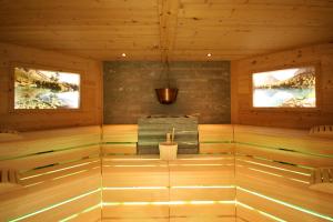 a sauna with a bench in a wooden cabin at Hotel Rosatsch Residence in Pontresina