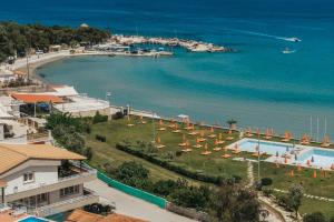 a view of a beach with umbrellas and the water at Boho Sea View Studio in Planos