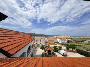a view of a building with an orange roof at Apartman Lucija 5 in Zubovići