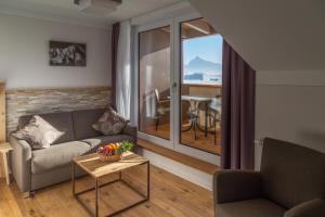 a living room with a couch and a table at Hotel Christine in Eisenberg