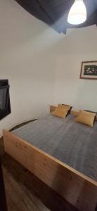 a large bed in a room with a tv at LAKEview HAUS in Braslovče