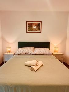 a bedroom with a bed with a towel on it at Fűzliget2- Green Lake in Balatonfůzfő