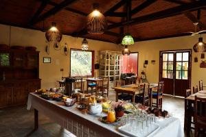 a large room with a table with food on it at Pousada Rancho da Serra PETAR in Iporanga