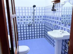 a blue and white bathroom with a sink and a toilet at Senu Ceylon Ella in Ella +108 photos