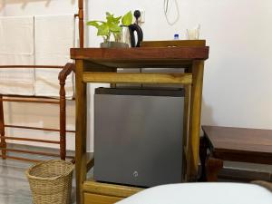 a wooden table with a plant on top of it at Senu Ceylon Ella in Ella