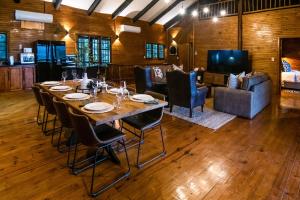 a dining room with a long table and chairs at 56 Crocodile in Komatipoort