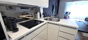 a kitchen with a sink and a counter top at Apartman Jo Ma MA in Solin