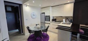 a kitchen with a table and chairs and a sink at Apartman Jo Ma MA in Solin
