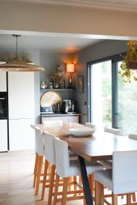a kitchen and dining room with a wooden table and chairs at Chambre confortable Piscine Maison EtxeCosy in Bidart