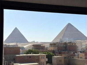 a view of the pyramids from a window at Pyra King Royal Pyramids Hotel in Cairo