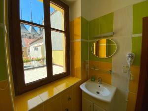ein Badezimmer mit Waschbecken und Fenster in der Unterkunft Hotel U Radnice in Louny + 63 Fotos