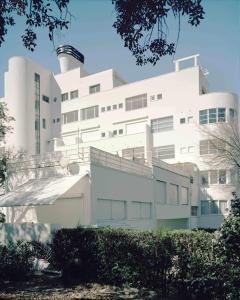 a white building with a tower on top of it at ÉLÉGANT STUDIO et PARKING DANS BATIMENT HISTORIQUE in Saint-Tropez