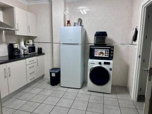 a kitchen with a refrigerator and a washing machine at San Pedro del Pinatar Lo Pagan, Calle Gibraltar 19 - app 2A in San Pedro del Pinatar