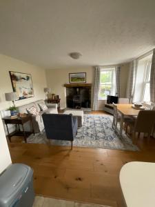 a living room with a couch and a table at Dale Grange in Askrigg
