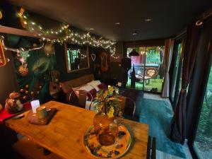 a living room with a wooden table and a dining room at La Cabane Enchanteresse in Illoud +14 photos