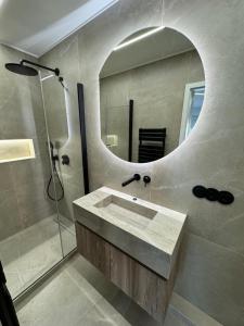 a bathroom with a sink and a mirror at Esch City Studio in Esch-sur-Alzette +1 photo