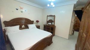 a bedroom with a large bed and a mirror at Chez Eva Jolie in Dakar