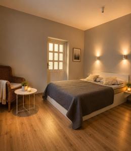 a bedroom with a bed and a table and a chair at V36 Apartments in Palanga +50 photos