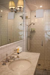 a bathroom with a sink and a shower at The Virginia and Cottages in Cape May +26 photos