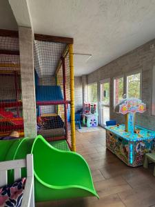 a room with a play room with a playground at Domek Na Gwizdówce nr52 in Załakowo