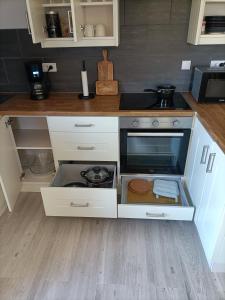 a kitchen with white cabinets and a counter top at Le Petit Manoir Vaillac in Fonmourenne
